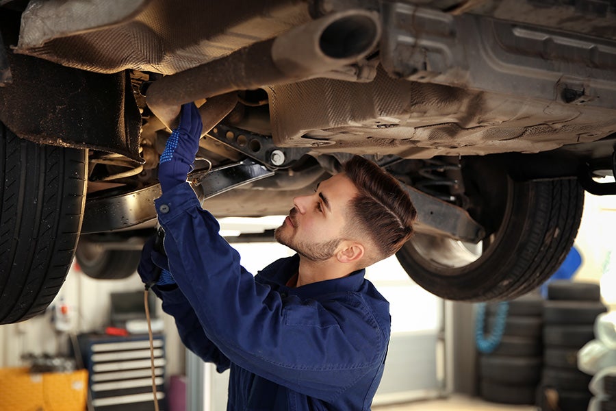 A service tech working on a car